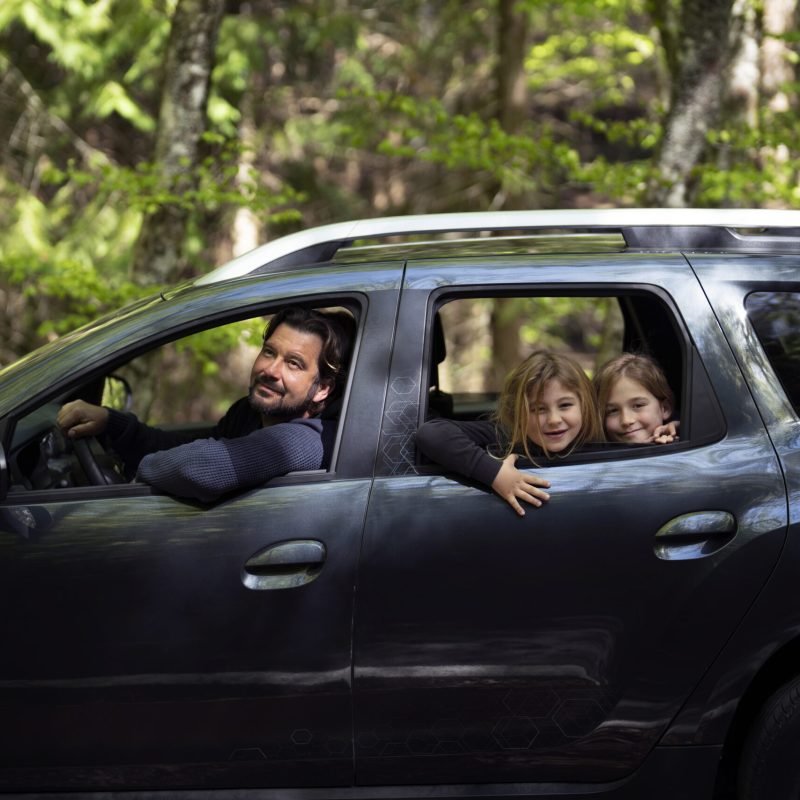 side-view-family-traveling-by-car